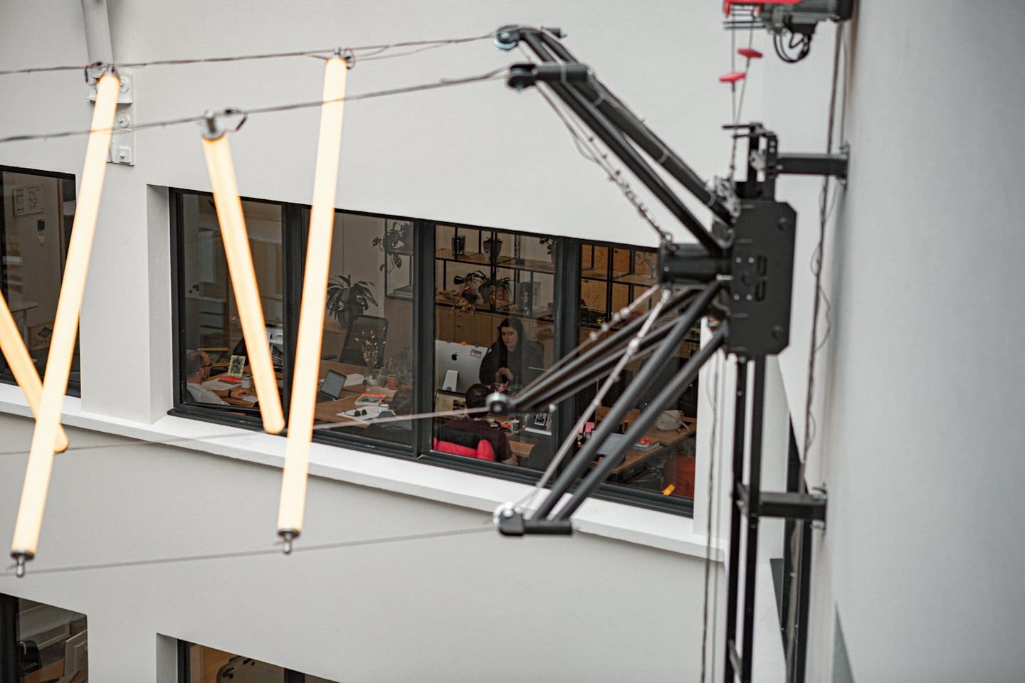 Office professionals work at their desks in a modern workspace.